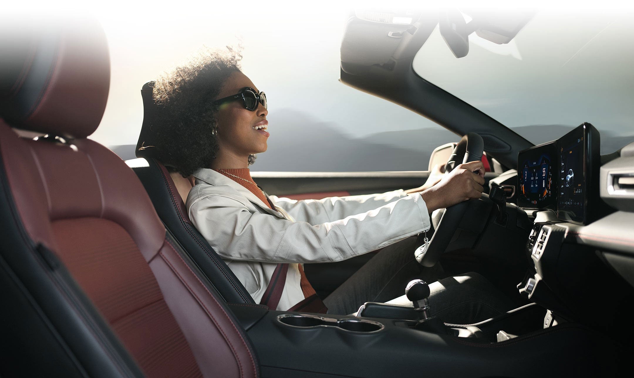 Person sitting in the driver’s seat of a 2024 Ford Mustang® convertible | Bailey Toliver Ford in Stanton TX